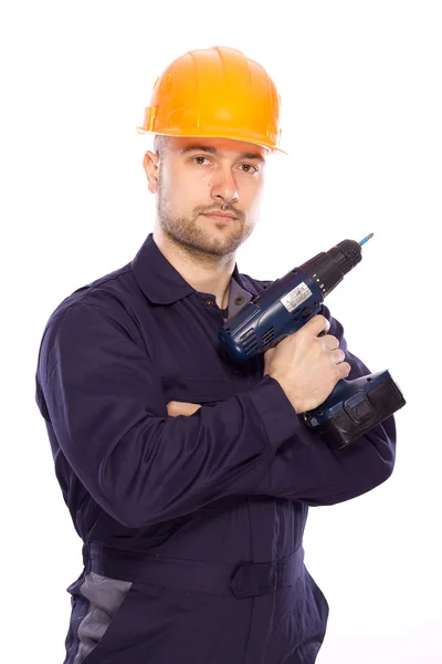 Retrato de um construtor com uma broca nas mãos sobre um fundo branco — Fotografia de Stock