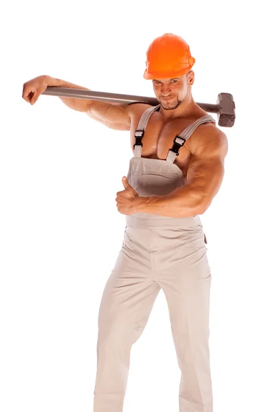 Young and handsome builder with a sledgehammer and sexy body — Stock Photo, Image