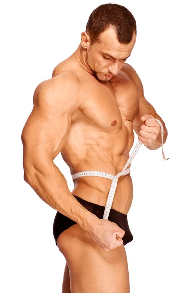 Muskulösa och garvade manliga kroppsdelar mäts — Stockfoto