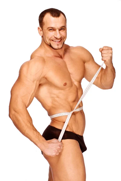Muskulösa och garvade manliga kroppsdelar mäts — Stockfoto