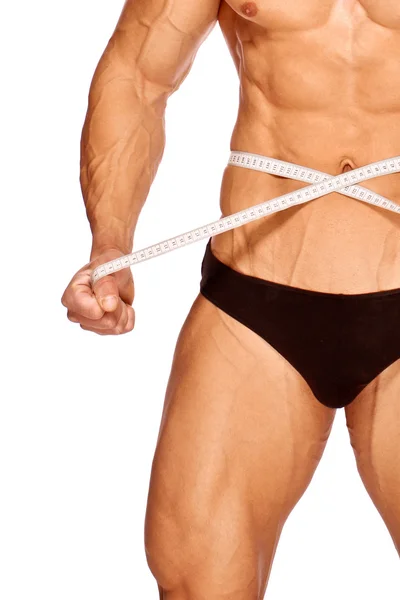 Gespierde en gebruinde mannelijke lichaamsdelen worden gemeten — Stockfoto