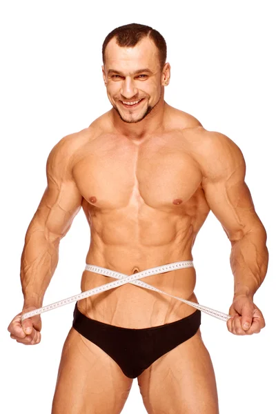 Les parties musculaires et bronzées du corps masculin sont mesurées — Photo