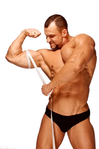 Gespierde en gebruinde mannelijke lichaamsdelen worden gemeten — Stockfoto
