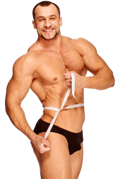 Partes do corpo masculino musculoso e bronzeado está sendo medido Fotografias De Stock Royalty-Free