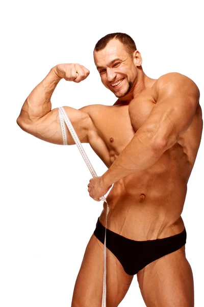 Partes do corpo masculino musculoso e bronzeado está sendo medido Fotografia De Stock