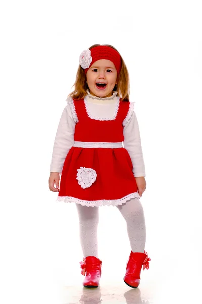 Una niña con un vestido de punto sobre un fondo blanco —  Fotos de Stock