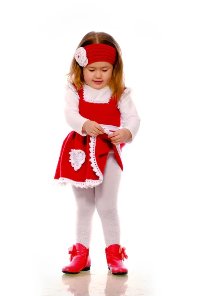 Una niña con un vestido de punto sobre un fondo blanco — Foto de Stock