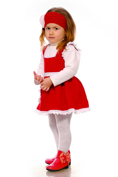 Dziewczynka w sukienkę z dzianiny, na białym tle — Zdjęcie stockowe