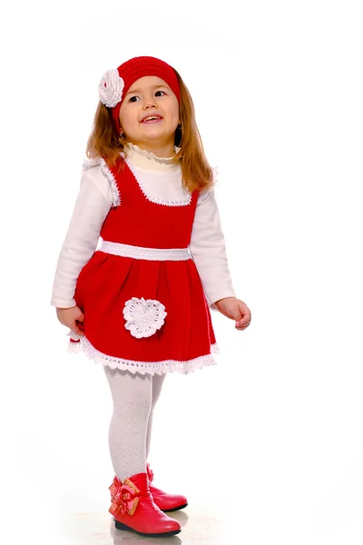 Dziewczynka w sukienkę z dzianiny, na białym tle — Zdjęcie stockowe