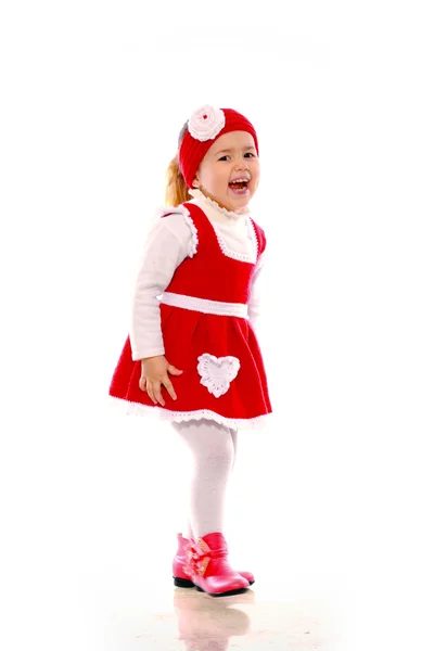 Beyaz zemin üzerine örme elbise giymiş küçük bir kız — Stok fotoğraf