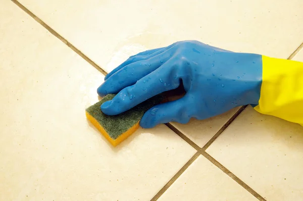 Hand wearing a working glove and a sponge — Stock Photo, Image