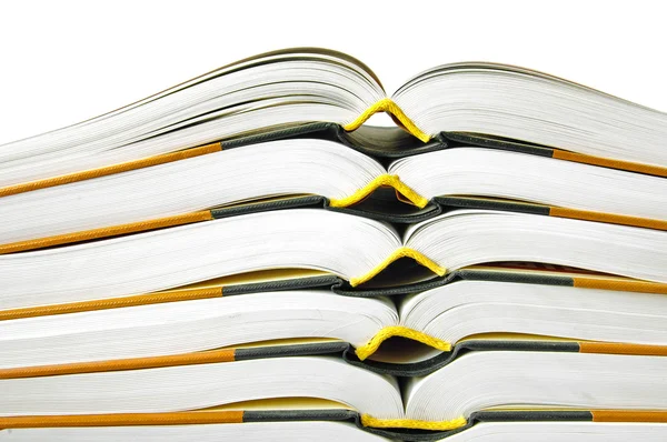 Pile of open books in closeup over white background — Stock Photo, Image