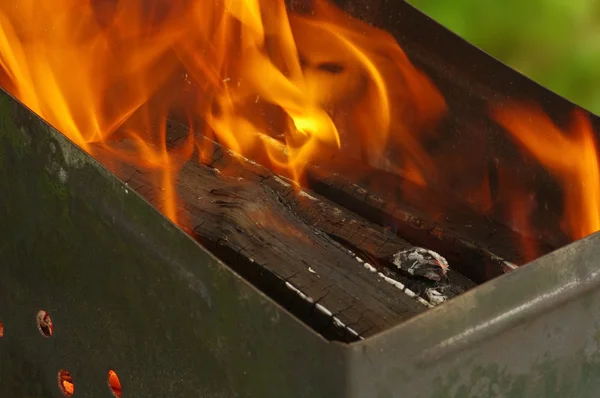 Wood burning in a barbeque grill — Stock Photo, Image