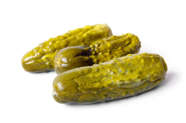 Three pickled cucumbers. Gherkins. Isolated on white. — Stock Photo, Image