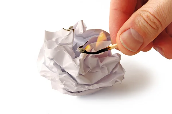 Man is trying to burn Crumpled paper isolated on white — Stock Photo, Image