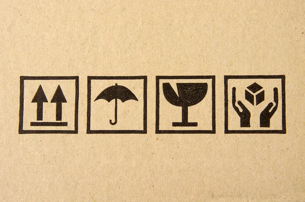 Imagen de primer plano del símbolo frágil negro grunge en cartón Imagen de archivo