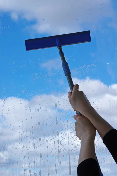 Hands with squeegee cleaning the misted window — Stock Photo, Image