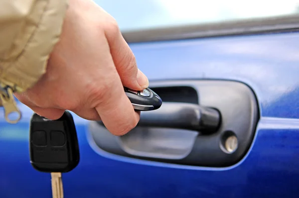 Stock image Hand opening the car door with a remote control