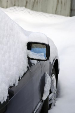 Heavy snow around car mirror clipart