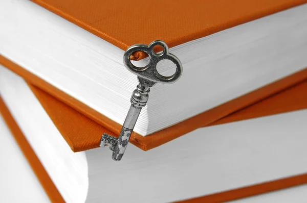 Books and key isolated on white — Stock Photo, Image