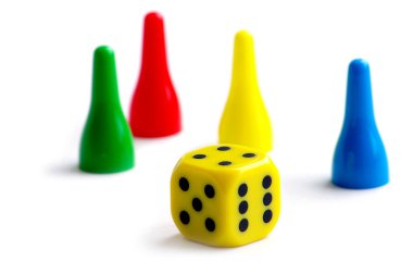 Pawns in green, yellow, red and blue with a cube clipart