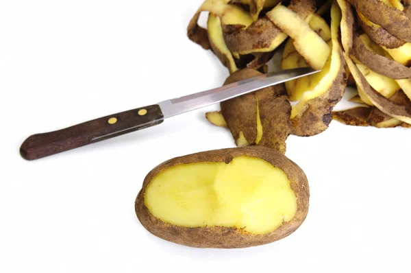 Half peeled potato, knife and potato peel isolated on the white — Stock Photo, Image