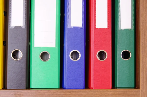 Colorful office folders on the bookshelf — Stock Photo, Image