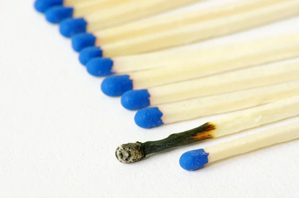 Macro closeup of a group of matches, one match burned, isolated — Stock Photo, Image