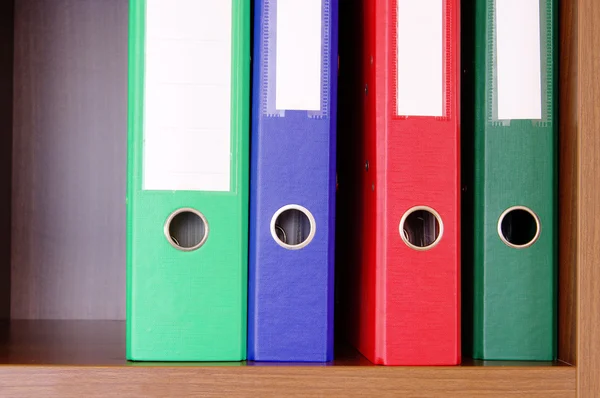 Colorful office folders on the bookshelf Royalty Free Stock Photos