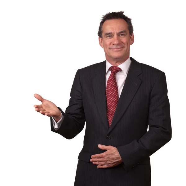 Homem de negócios de meia idade no terno Sorrindo e Gesturing Bem-vindo — Fotografia de Stock