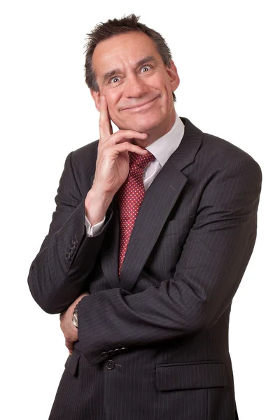 Business man in pak met dwaze grijns en hand onder ogen zien — Stockfoto