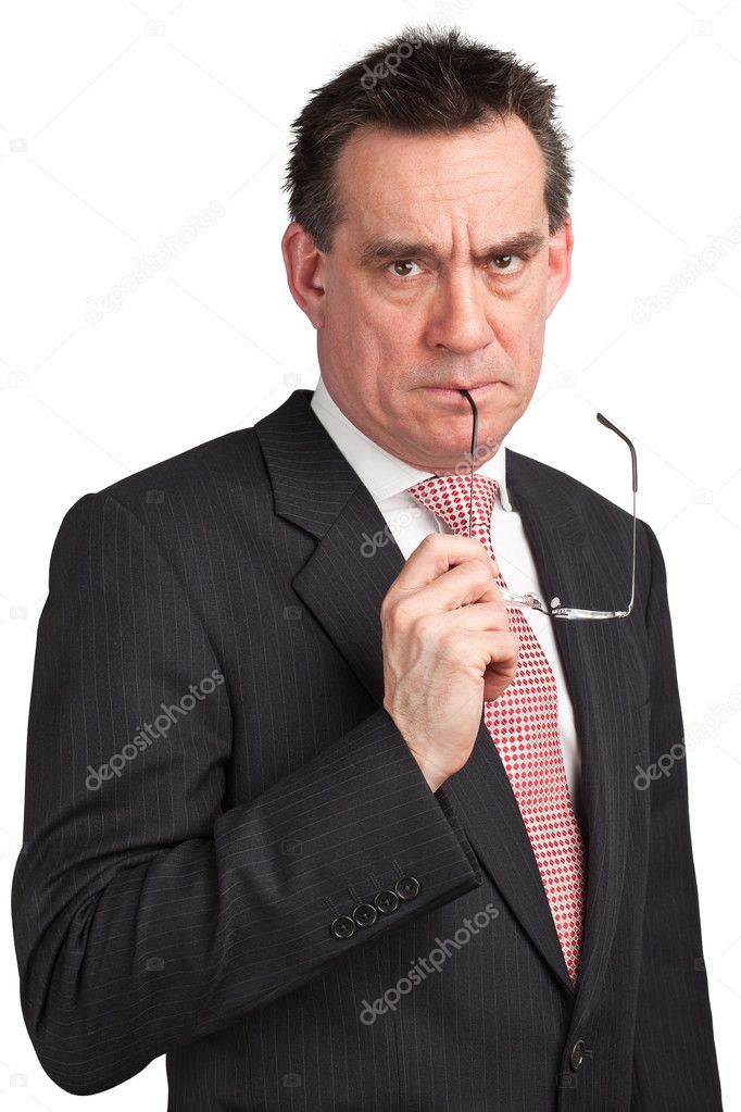 Frowning Angry Business Man in Suit holding glasses