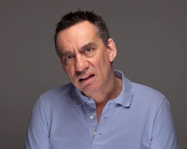 Man Pulling Unhappy Face on Grey Background — Stock Photo, Image