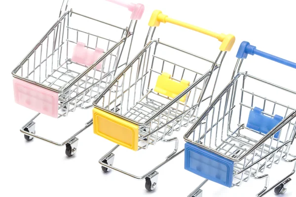 Shopping carts on white, closeup — Stock Photo, Image