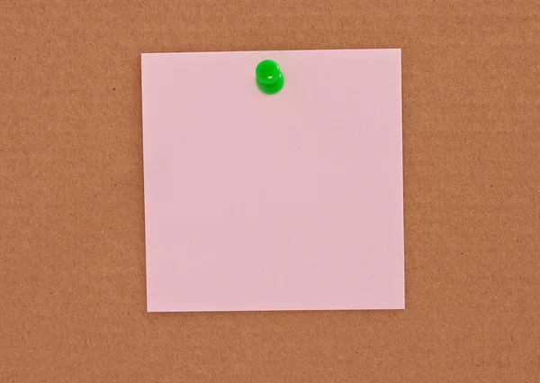 stock image Pink note paper attached with green pin