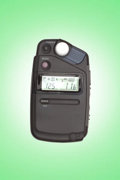 Cyfrowy flashmeter, na białym tle na zielony backrgound — Zdjęcie stockowe
