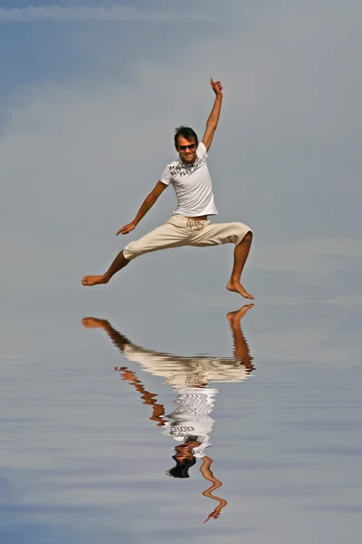 stock image Man jumping on the beach