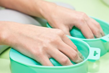 The process of steaming hands before manicure clipart