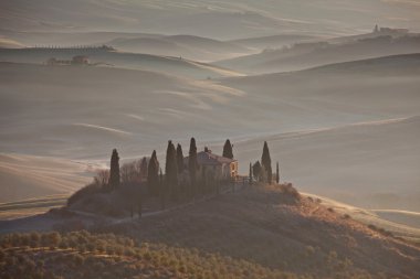 Classic Tuscany landscape with farmhouse and mist clipart