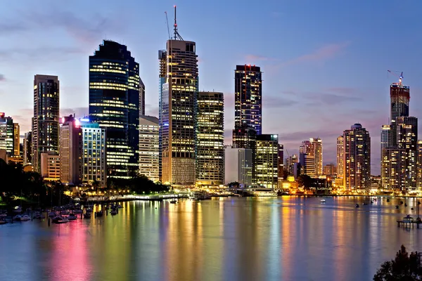 Brisbane city reflected in the river at sunset — Stok fotoğraf