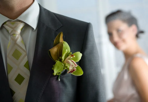 Husband with corsage and Bride behind — Stock Photo, Image