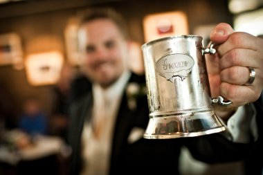 Groom holding a metal tankard clipart