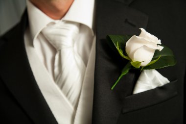 Close up of a white rose corsage on a Groom clipart