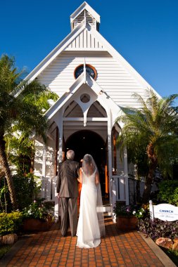 Father standing with bride outside a church clipart