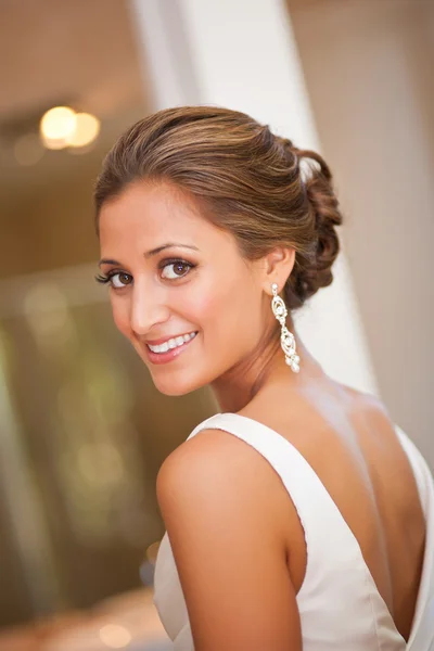 Beautiful bride looking over her shoulder — Stock Photo, Image
