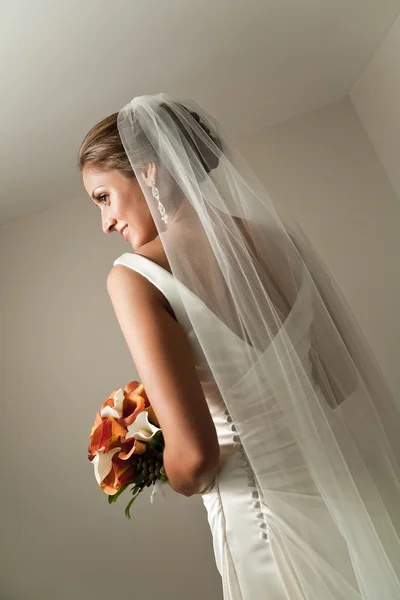 Bela noiva por trás mostrando seu véu — Fotografia de Stock