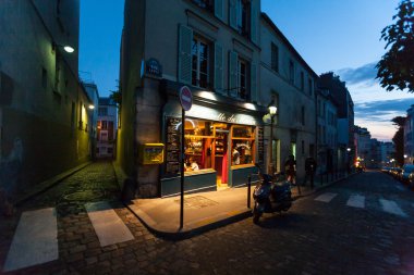 A classic parisian cafe at night clipart