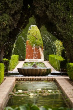 A fountain in the Generalife gardens of the Alhambra palace clipart