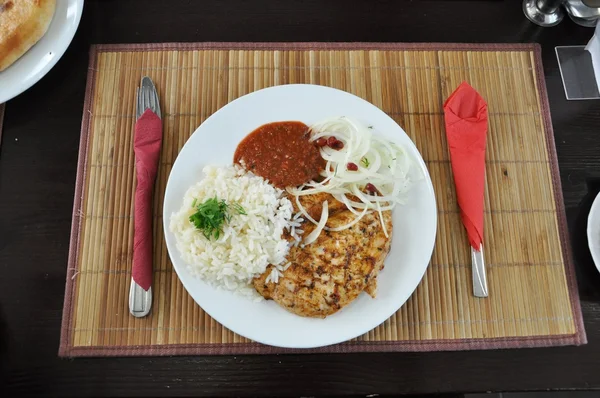 Stock image Chicken, rice and sauce on a platter.