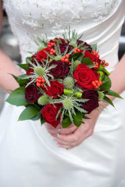 Bride holding a bouquet of roses clipart